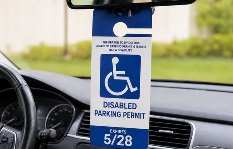 A Florida disabled parking placard hanging from a car's rear-view mirror